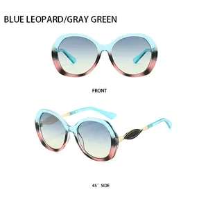 Vorder- und Seitenansicht der ovalen Verlaufs-Sonnenbrille mit goldener Verzierung