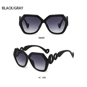 Close-up of hexagonal black sunglasses with gray gradient lenses and hollow ring temples