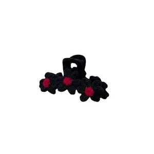 Retro knitted floral hair claw clip in black with red accents for elegant hairstyling