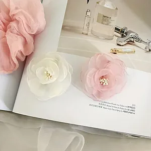 Sweet pink and creamy white camellia hair clips made of delicate mesh fabric
