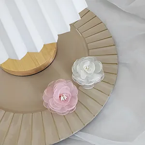 Pink and white fabric camellia hair clips with organza layers and white stamens