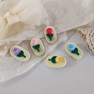 Detailed view of 3D colorful rose charms for hair clips or shoe accessories in five colors