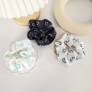 Three-piece satin scrunchie set with smiley face prints in black and white colors