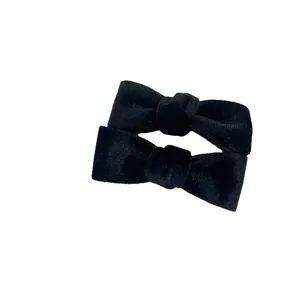 Elegant pair of black velvet bow hair clips for women with a premium matte finish