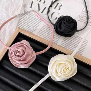 Detailed view of handmade satin rose chokers in pink, black and beige colors