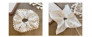 Detailed view of white polka dot lace hair tie with vintage crochet edge and long ribbons