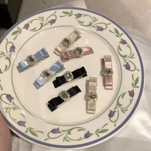 8-piece set of elegant bow hair clips with rhinestones in pink, blue, black, and champagne