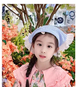 Close-up of blue and white plaid girls' bandana featuring multi-layered lace ruffles