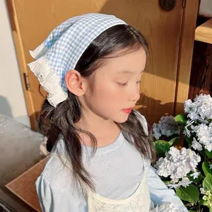 Blue and white plaid headband with white lace trim shown on a child in a home setting