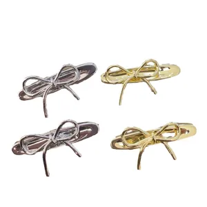 Golden and silver metal bow hair clips in a minimalist Korean style for women