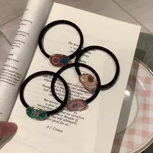 Blumiges Harz-Haargummi-Set mit 4 Stück auf Vintage-Buch für Damen