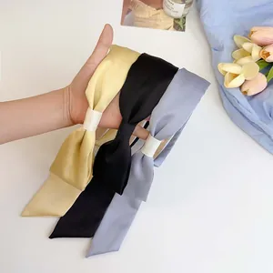 Elegant wide satin headband with long French bow ribbons in yellow, black, and blue colors