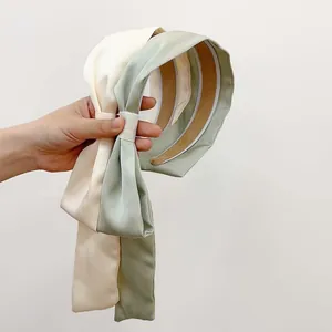 Elegant wide satin headband with long ribbons in cream white and light green