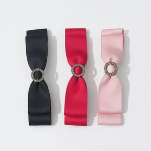 Detail von Satin-Schleifen-Haarspangen in Schwarz, Rot und Rosa mit Strass-Verzierung