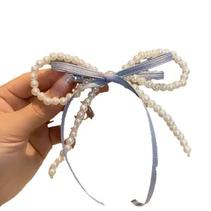 Elegant pearl bow hair clip with light blue ribbon center for stylish hairstyles