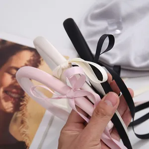Elegant satin bow headband in black, pink and white colors for a ballet-inspired look