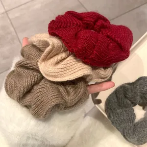 Handmade knitted wool scrunchies in red, beige, and coffee for autumn and winter hairstyles
