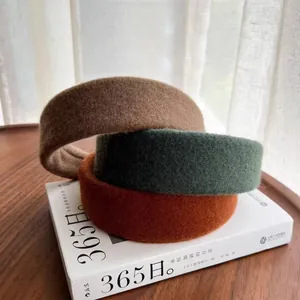 Three-piece set of wide wool felt headbands in brown, dark green, and caramel colors