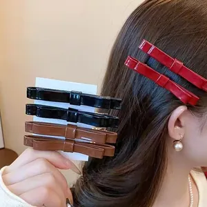 Glossy leather double bow hair clips for women in black, brown and wine red set