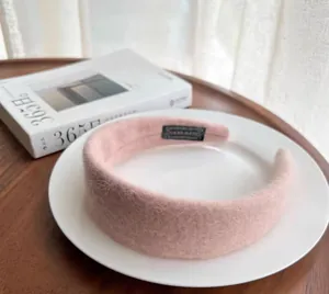 Detail of pink wool felt headband showing soft plush texture and handmade label