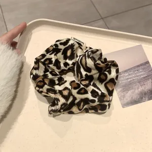 Détail du chouchou en velours léopard avec étiquette faite main sur un plateau