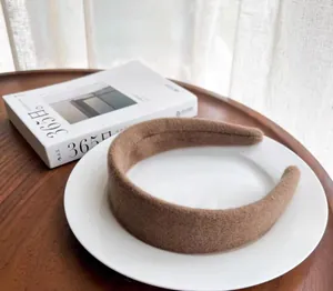 Detail of wide-brimmed khaki wool felt headband with soft thick padded texture