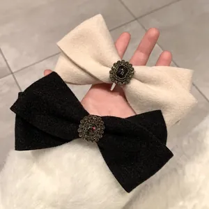 Elegant wool bow hair clips in black and beige with vintage gemstone buckles