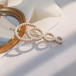 Elegant gold metal hair clip with white pearls in a four-ring vintage design