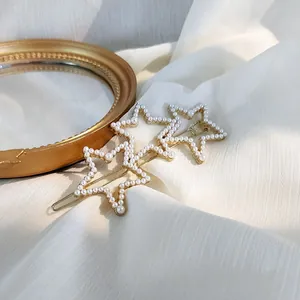 Golden hair clip featuring three connected stars with white pearl inlay and jelly texture