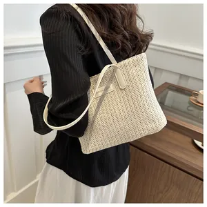 Detail of minimalist cream straw tote bag with elegant Fashion & Bags patch texture