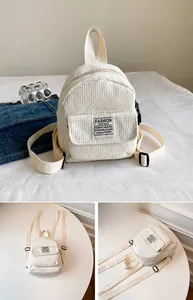 Detail view of cream corduroy mini backpack with front pocket and adjustable straps