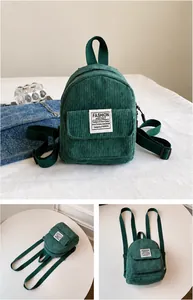 Detail of green corduroy mini backpack featuring front pocket and fashion label patch