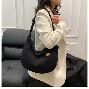 Detailed view of black corduroy shoulder bag, casual hobo tote design with spacious interior.