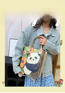 Detail of the panda and flower canvas tote bag showing the soft woven handle and print