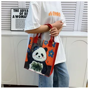 Detail of red panda tote bag showing soft felt material and cute artistic hand-drawn panda