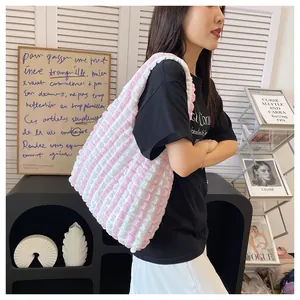 Detail of the pink and white striped pleated fabric texture on a stylish cloud tote bag