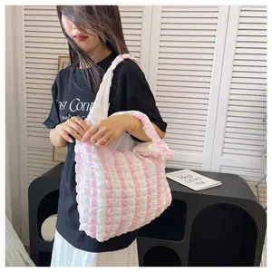 Detail of pink and white striped ruched tote bag with unique bubble texture fabric