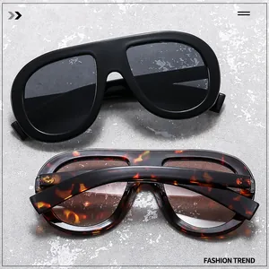 Flat top aviator sunglasses in black and tortoiseshell finish on textured background