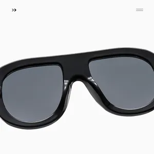 Detailed view of polished black oversized frames and gray lenses on these retro sunglasses