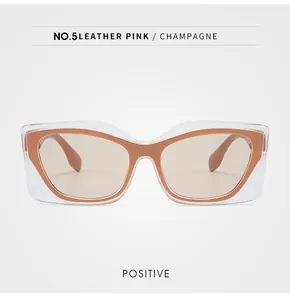 Vue de face de lunettes de soleil œil-de-chat avec monture contrastée champagne rose