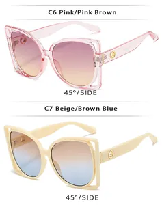 Detail view of square cat-eye sunglasses with cutout frames in pink and beige tones