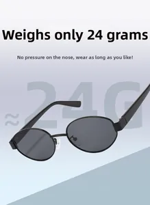Detail of lightweight oval black metal sunglasses weighing only 24g with gray lenses
