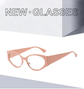 Detail of coral pink cat-eye frame with matte finish and wide temples for Y2K style
