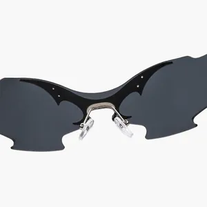 Detailed close-up of dark grey rimless butterfly wing sunglasses with a futuristic design