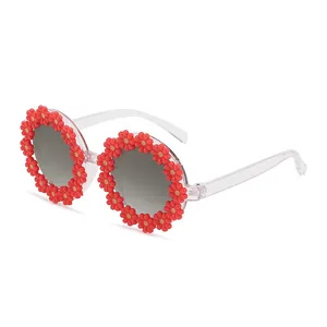 Fashionable round sunglasses with red daisy flowers and transparent frames for parties