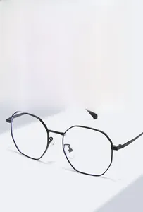 Detailed close-up of matte black polygonal metal glasses frame with clear lenses