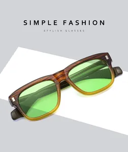 Detail of wood grain square sunglasses with green lenses and silver rivet accents