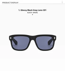 Detail of black square sunglasses featuring silver metal studs and gray lenses