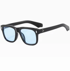 Detail view of square black frame sunglasses with light blue lenses and silver rivets