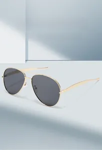 Close-up of classic aviator sunglasses with gold metal frame and dark lenses